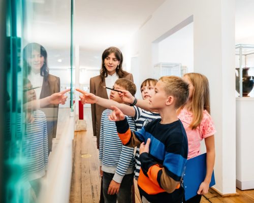 Kids Looking At Objects On Display In Museum